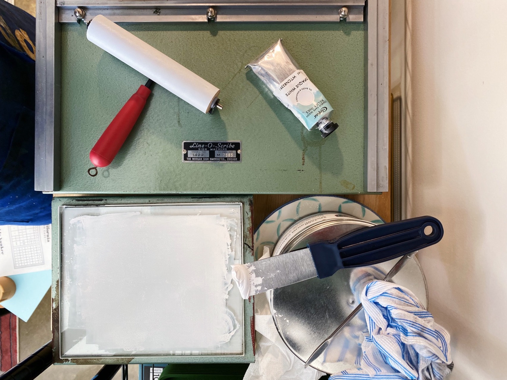 Photo of a printing press and some tools used in printing.